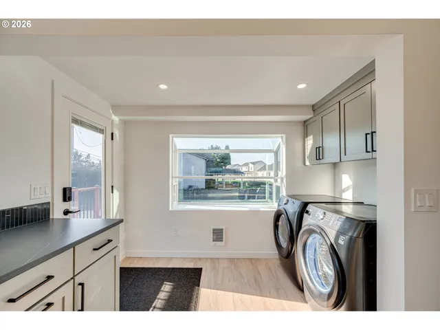 a view of a kitchen with washer and dryer
