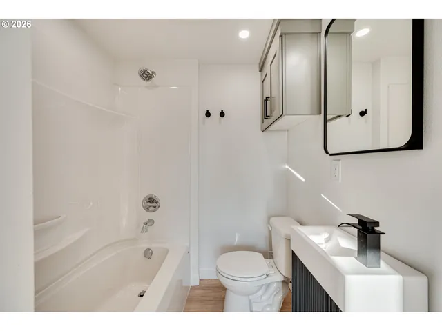 a bathroom with a sink toilet a shower and bathtub