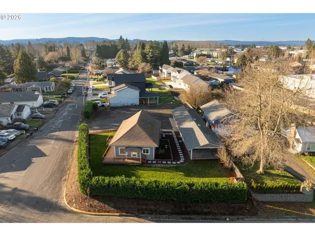 a view of a house with a yard and lake view