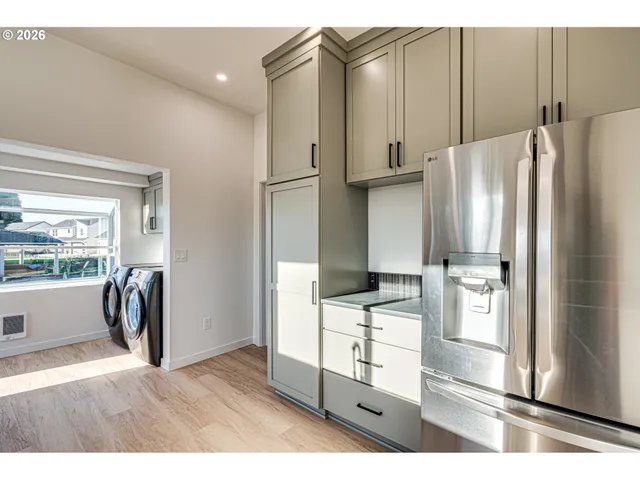 a kitchen with stainless steel appliances a refrigerator and a stove