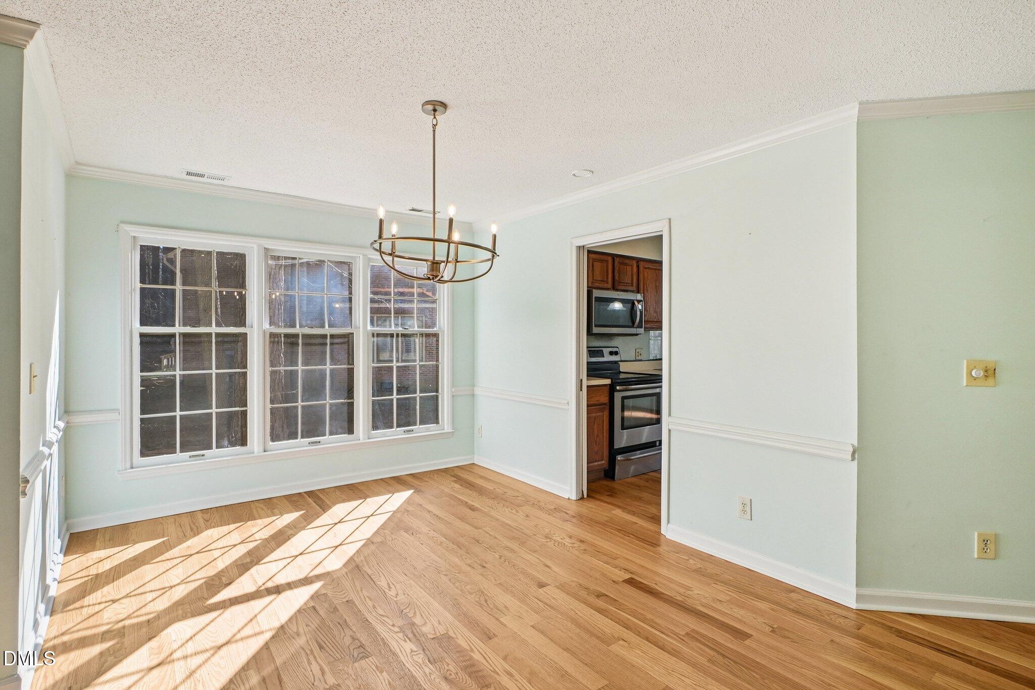 3305 Coachman's Way Durham, NC 27705 - Photo 5 of 35 a view of empty room with a window and wooden floor