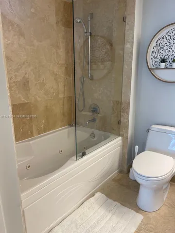 a bathroom with a toilet and a bathtub