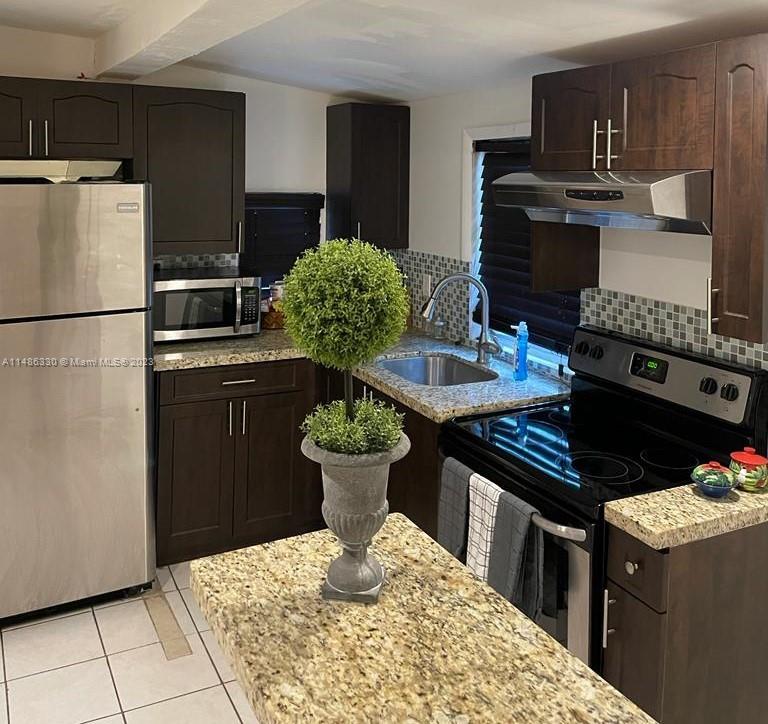 a kitchen with a stove and a refrigerator