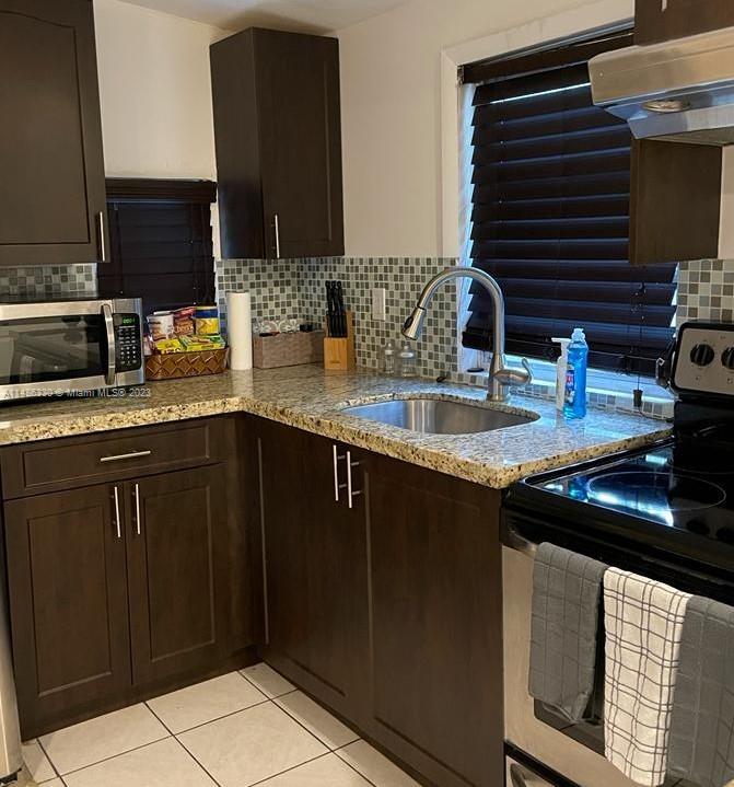 Wynwood Miami, FL 33127 - Photo 2 of 16 a kitchen with granite countertop a sink and a stove