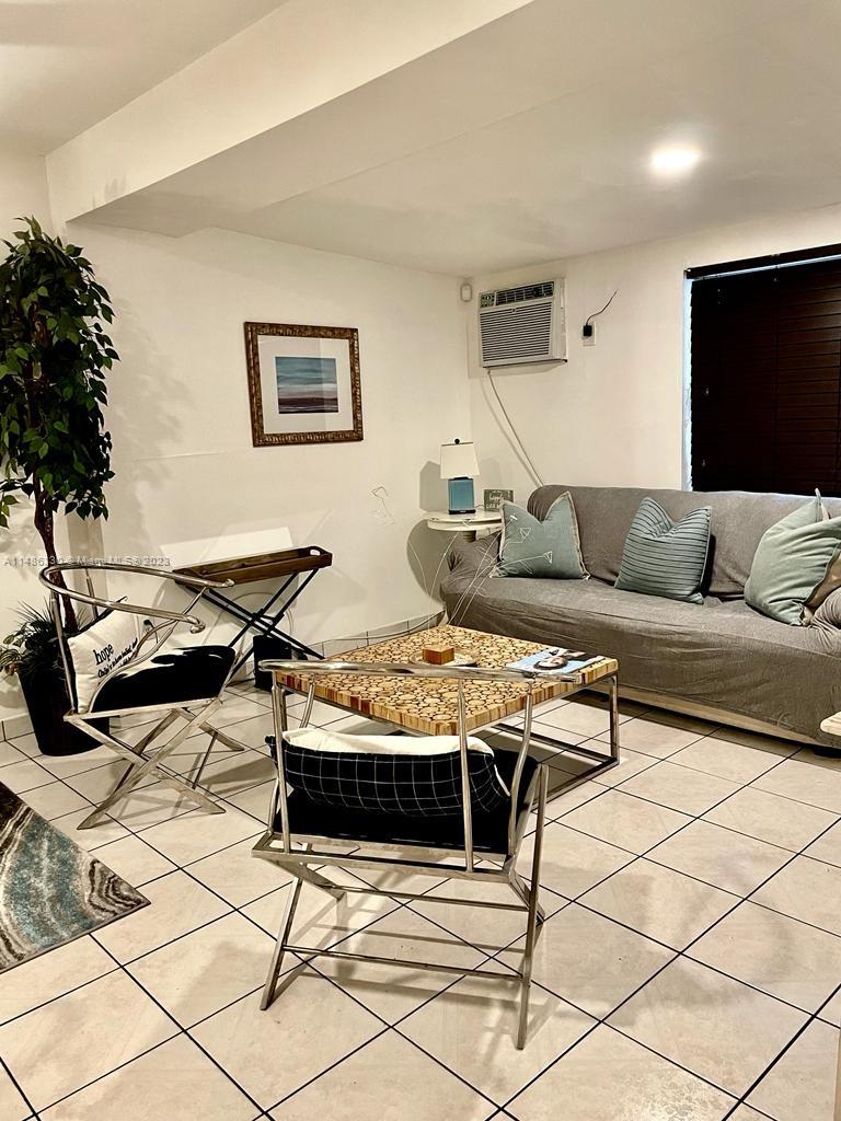 Wynwood Miami, FL 33127 - Photo 7 of 16 a living room with furniture and a flat screen tv