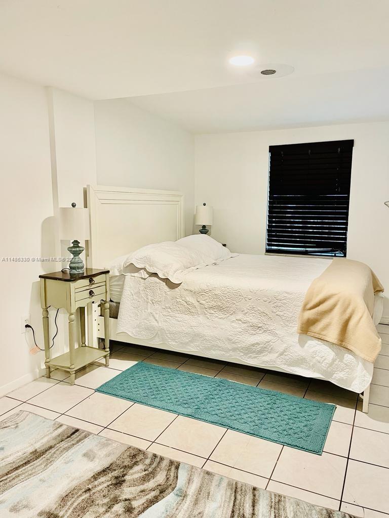 Wynwood Miami, FL 33127 - Photo 9 of 16 a bedroom with a bed and a flat tv screen