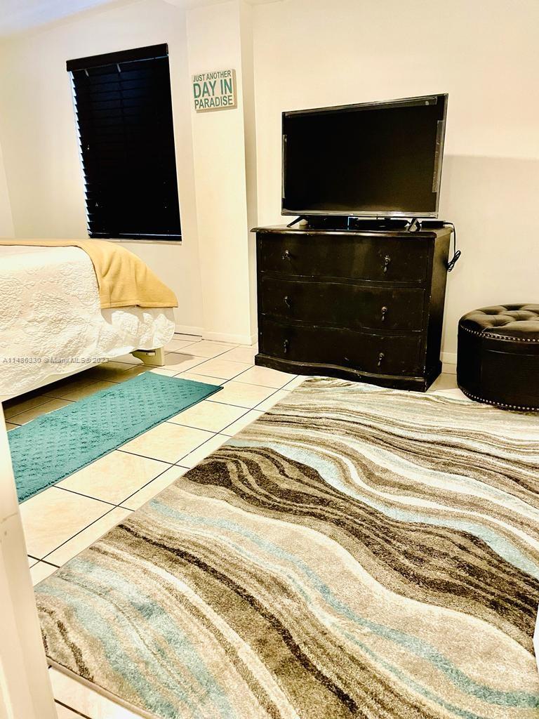 Wynwood Miami, FL 33127 - Photo 10 of 16 a bedroom with a bed and flat screen tv