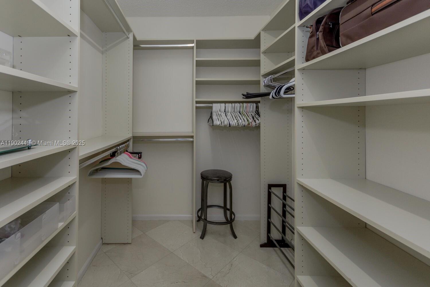 290 Celestial Way, Unit 2 Juno Beach, FL 33408 - Photo 11 of 40 a view of walk in closet with empty racks