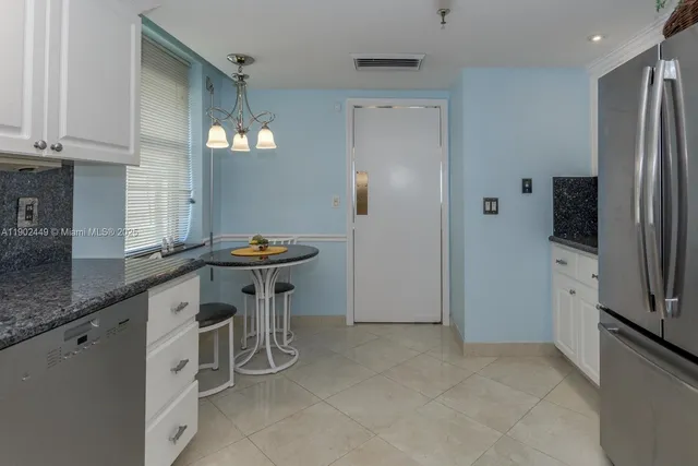 a kitchen with stainless steel appliances granite countertop a refrigerator and a sink