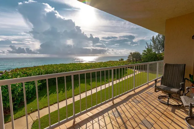 a view of balcony with wooden floor and fence
