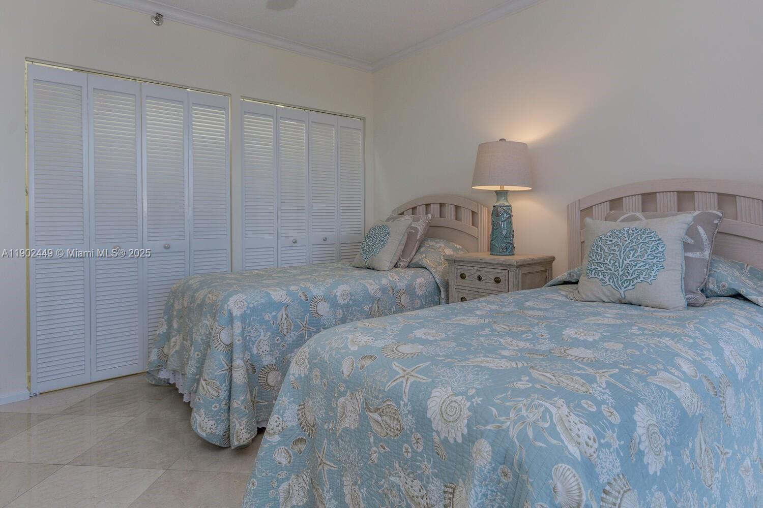 290 Celestial Way, Unit 2 Juno Beach, FL 33408 - Photo 20 of 40 a bedroom with a bed and a night stand