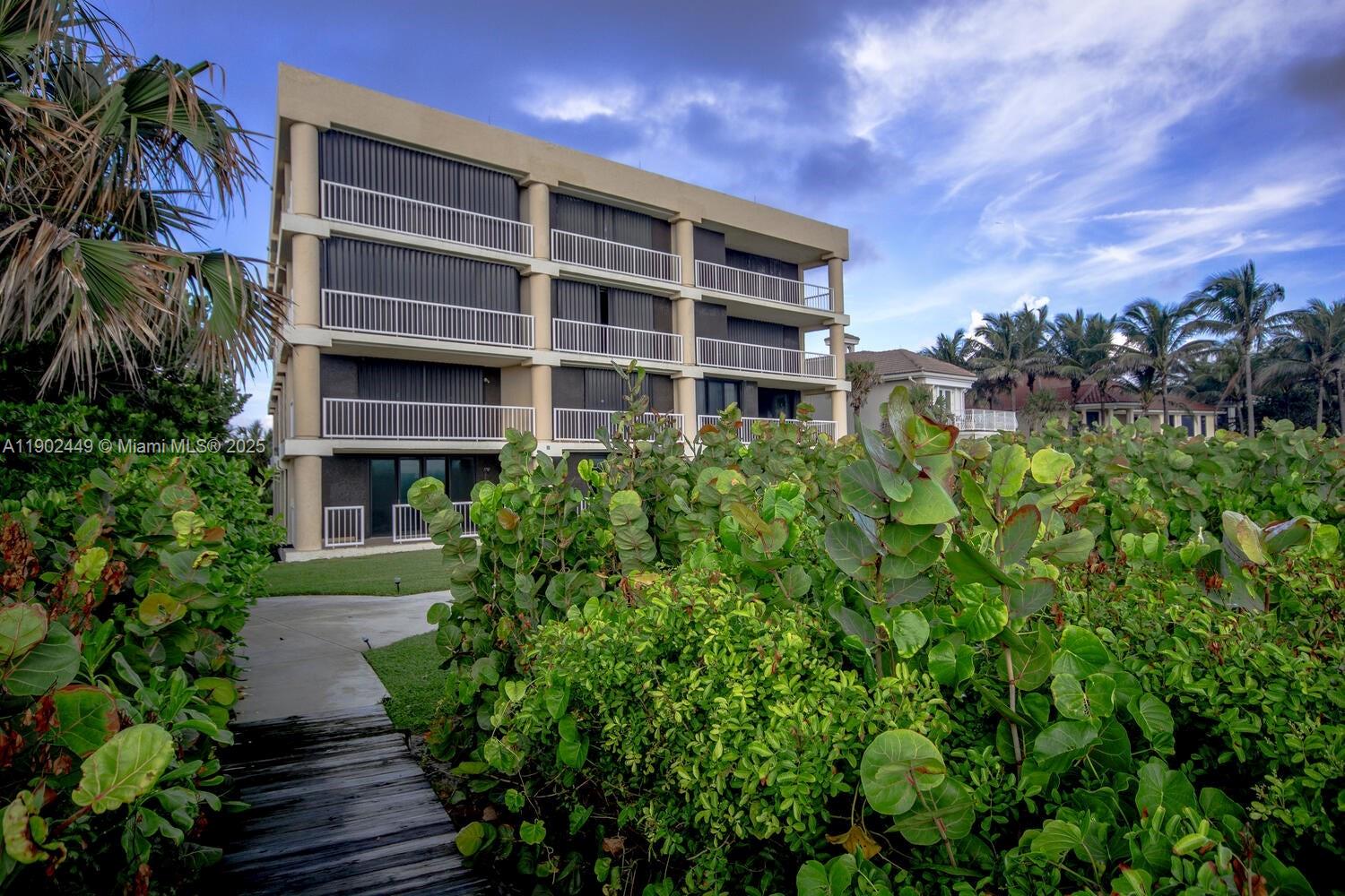 290 Celestial Way, Unit 2 Juno Beach, FL 33408 - Photo 31 of 40 a view of house with yard and green space