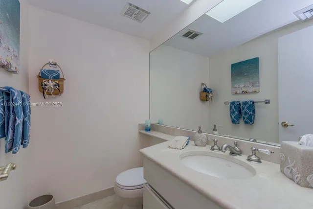a view of a hallway with wooden floor and cabinet