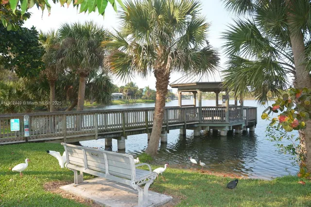 a view of a garden with a lawn chair and swimming pool