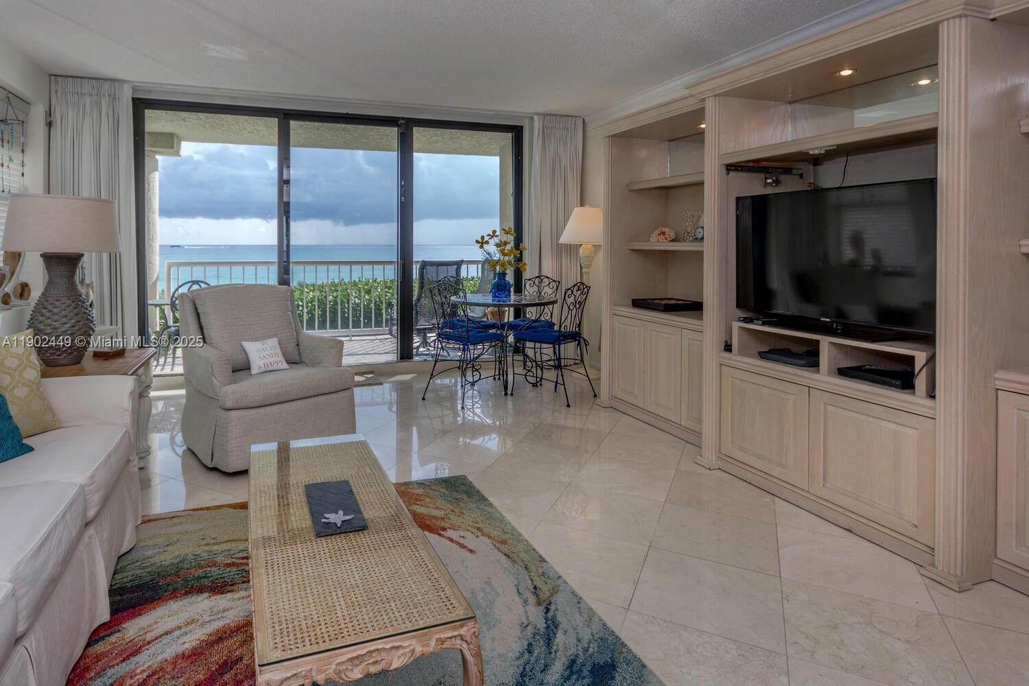 290 Celestial Way, Unit 2 Juno Beach, FL 33408 - Photo 6 of 40 a living room with furniture and a flat screen tv