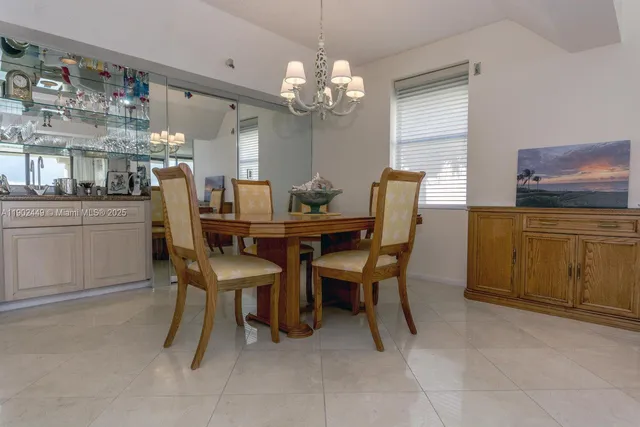 a dining room with furniture and chandelier