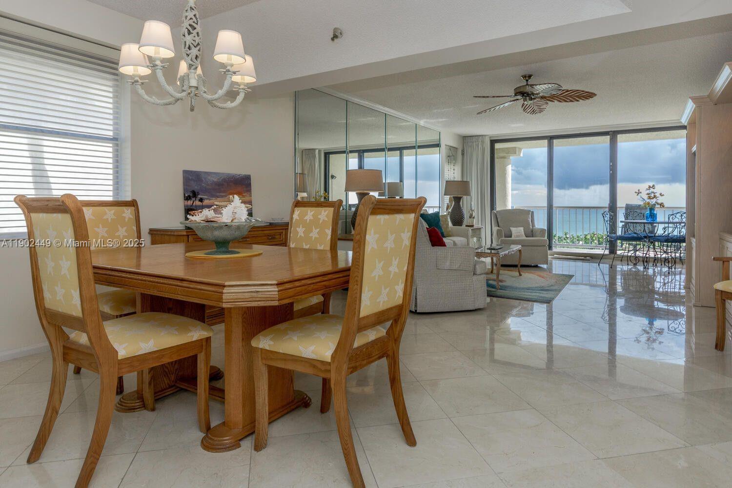 290 Celestial Way, Unit 2 Juno Beach, FL 33408 - Photo 8 of 40 a dining room with furniture a chandelier and window
