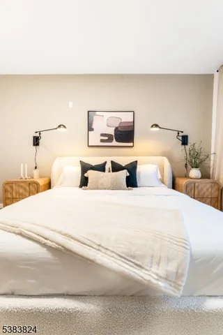 a bedroom with a bed and a night stand