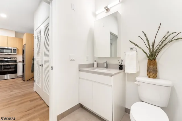 a bathroom with a toilet sink and a mirror