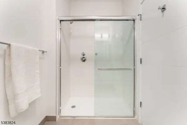 a bathroom with a glass shower door