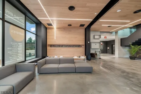 a living room with furniture gym equipment and a large window