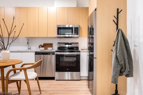 a kitchen with stainless steel appliances a stove a sink and a refrigerator
