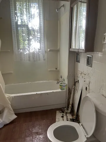 a bathroom with a sink a toilet and tub