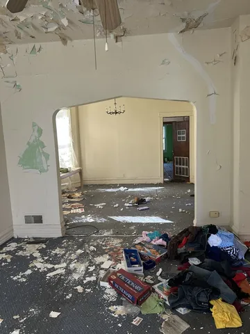 a kitchen with kitchen island granite countertop a stove a refrigerator and wooden cabinets