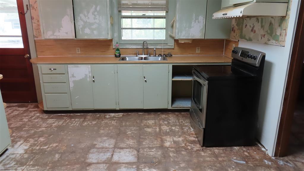 107 6th Street Northeast Springhill, LA 71075 - Photo 18 of 19 a kitchen with a sink a stove and cabinets