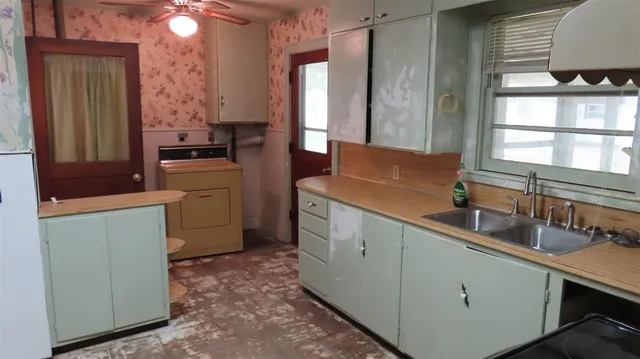 a kitchen that has a sink and a stove in it