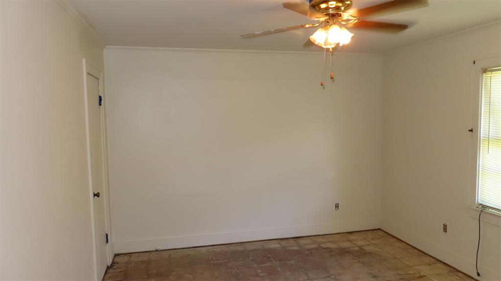 107 6th Street Northeast Springhill, LA 71075 - Photo 10 of 19 an empty room with a window and a chandelier fan