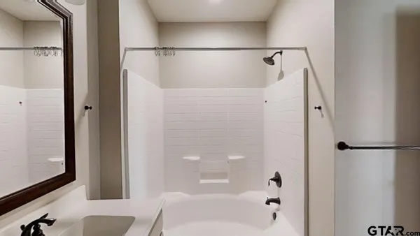 a bathroom with a shower and a tub