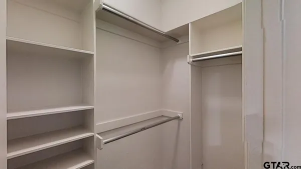 a view of an empty walk in closet