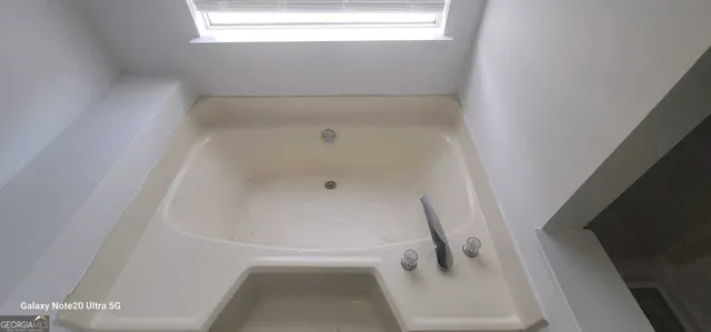 a room with a window and a ceiling fan