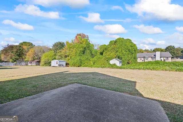 an aerial view of residential houses with outdoor space