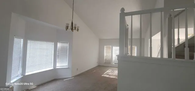 a view of a room with a windows and ceiling fan