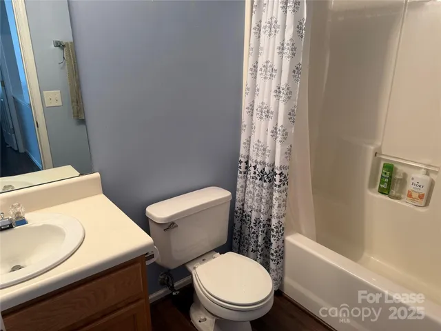 a white toilet sitting next to a bath tub