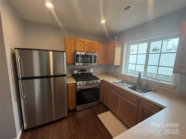 a kitchen with a refrigerator sink and stove