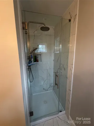 a bathroom with a glass shower door