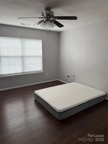 a bed sitting in a room next to a window