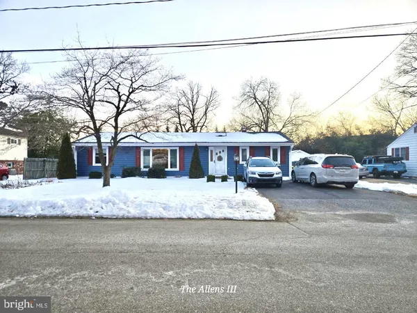 a front view of a house with a yard covered in snow