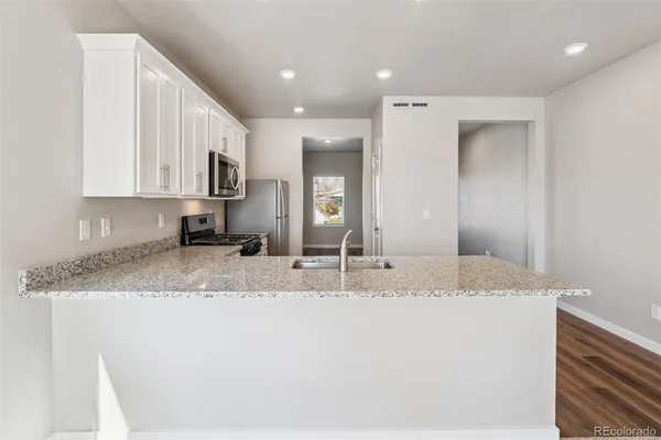 a view of a kitchen with a sink and cabinets