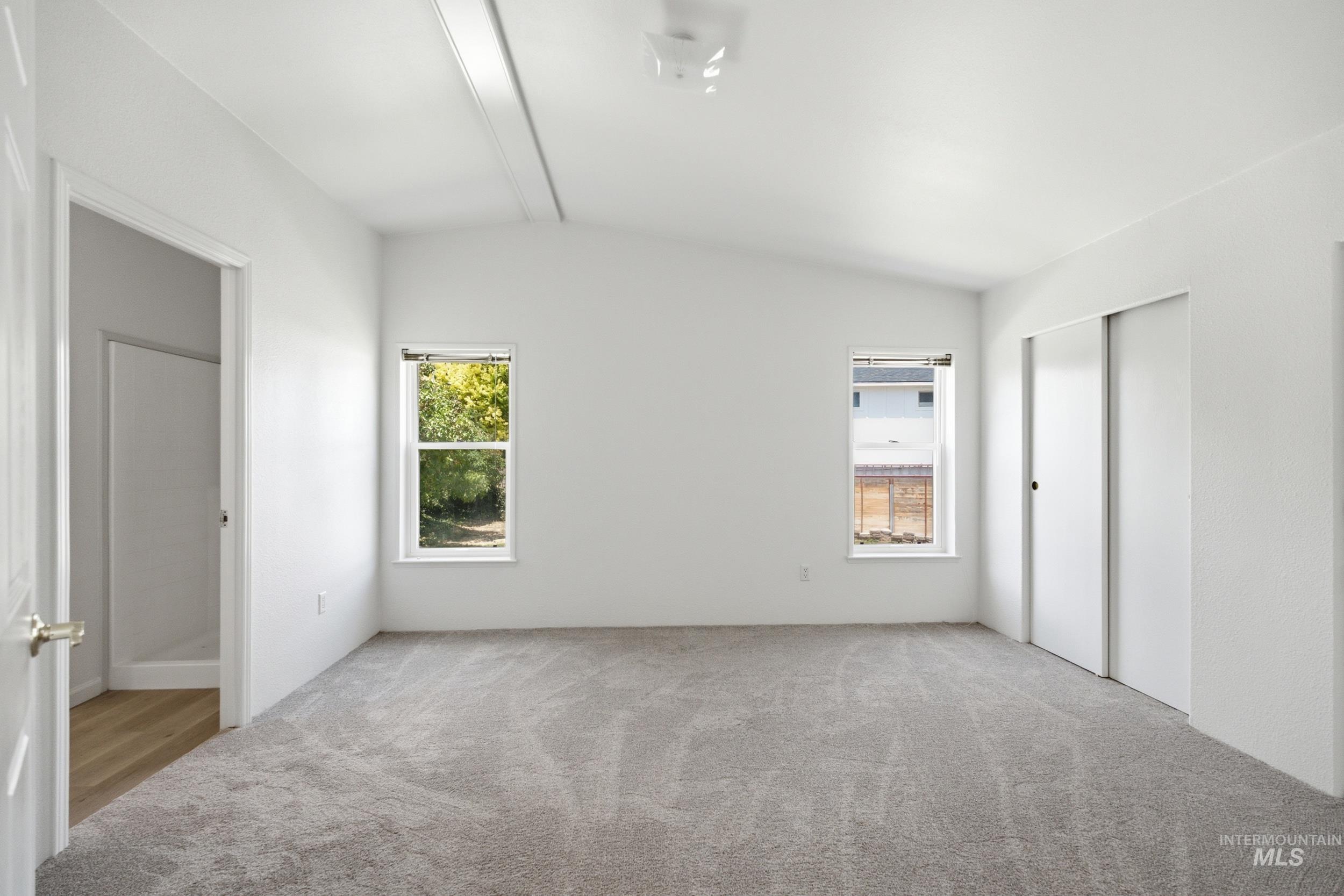 7422 Track Road Nampa, ID 83686 - Photo 19 of 50 Carpeted room featuring a double window, French doors, and a decorative stained-glass window