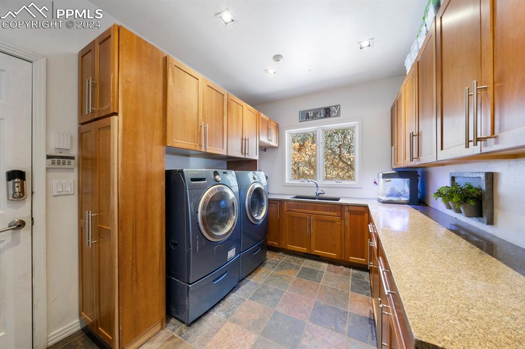 220 Preservation Way Colorado Springs, CO 80919 - Photo 12 of 39 a view of a kitchen with a sink dishwasher a fireplace with wooden cabinets