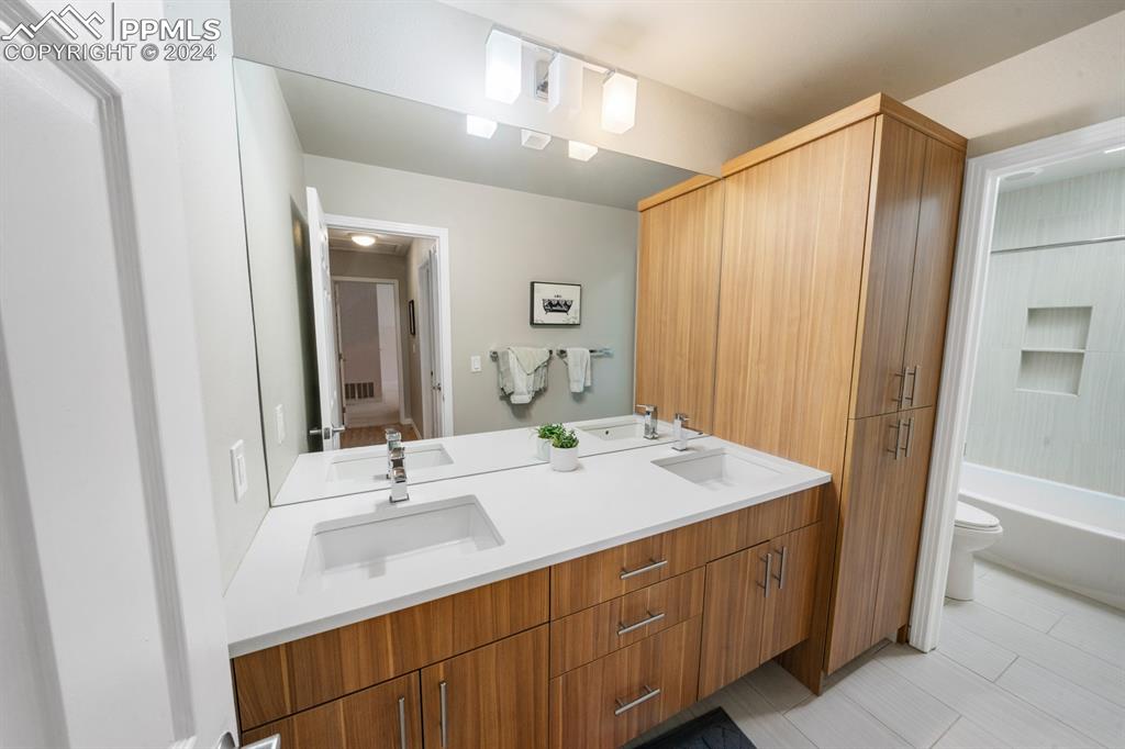 220 Preservation Way Colorado Springs, CO 80919 - Photo 21 of 39 a bathroom with a double vanity sink and a mirror