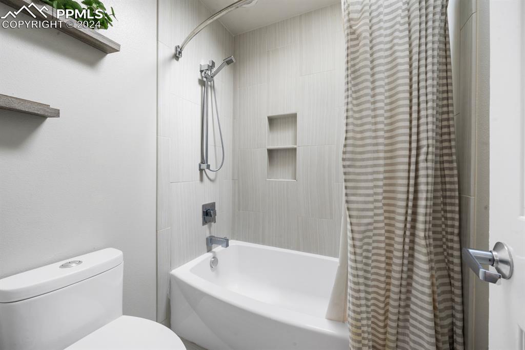 220 Preservation Way Colorado Springs, CO 80919 - Photo 22 of 39 a bathroom with a toilet a sink and shower