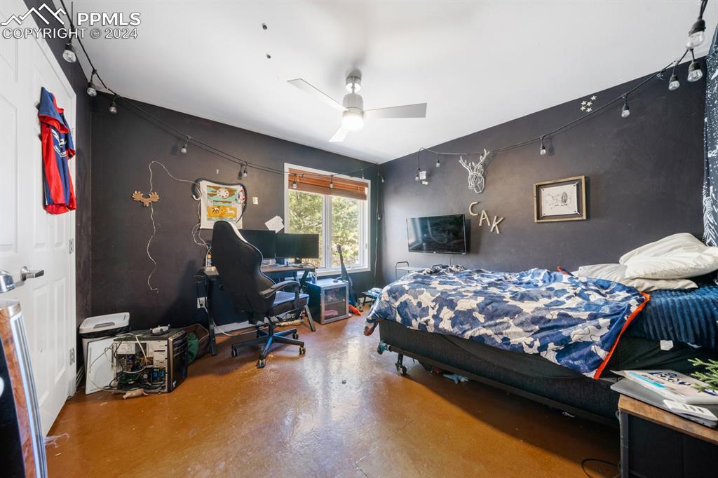 220 Preservation Way Colorado Springs, CO 80919 - Photo 23 of 39 a bed room with furniture and a flat screen tv