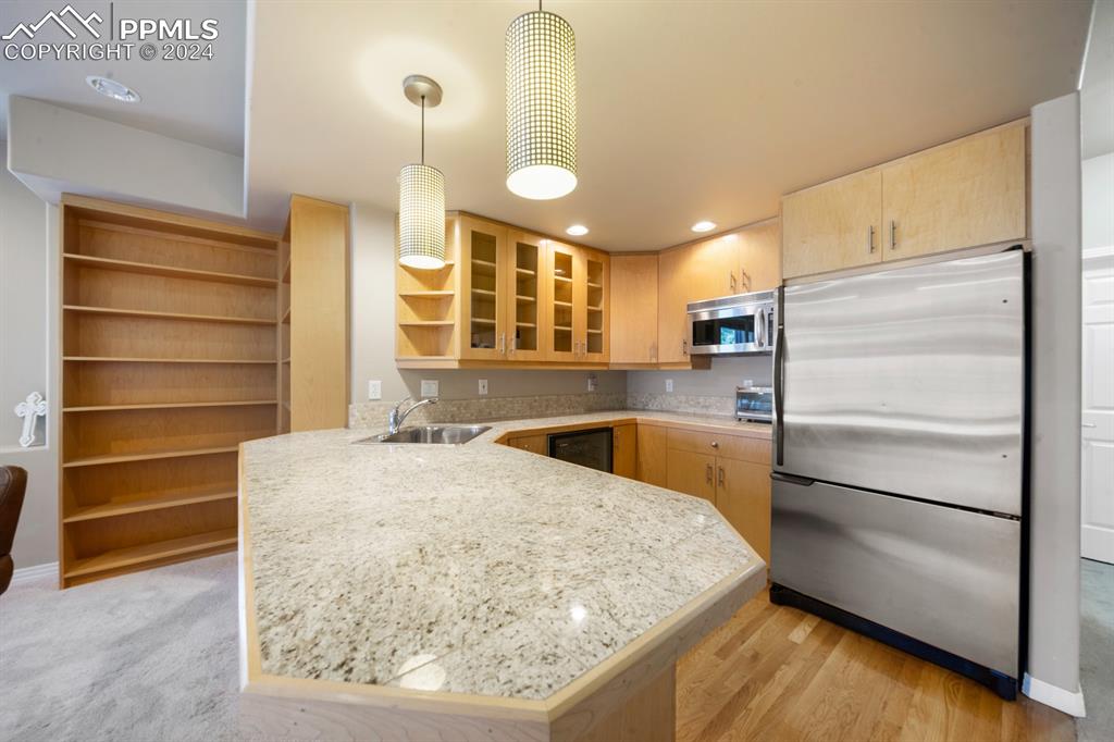 220 Preservation Way Colorado Springs, CO 80919 - Photo 24 of 39 a kitchen with a refrigerator and a sink
