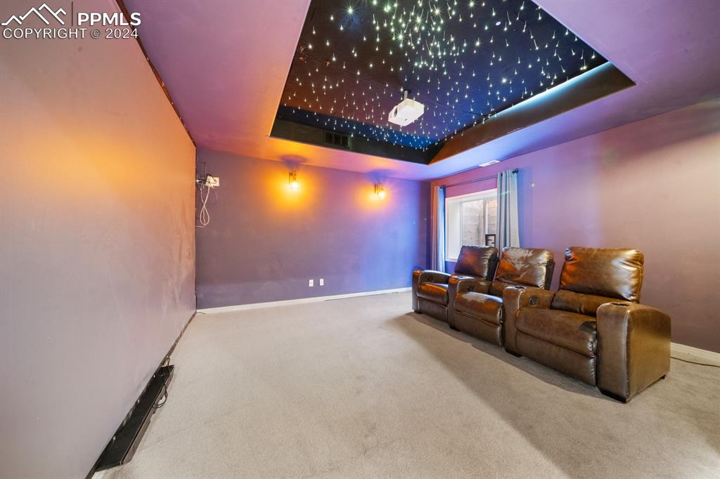 220 Preservation Way Colorado Springs, CO 80919 - Photo 27 of 39 a living room with furniture and a chandelier
