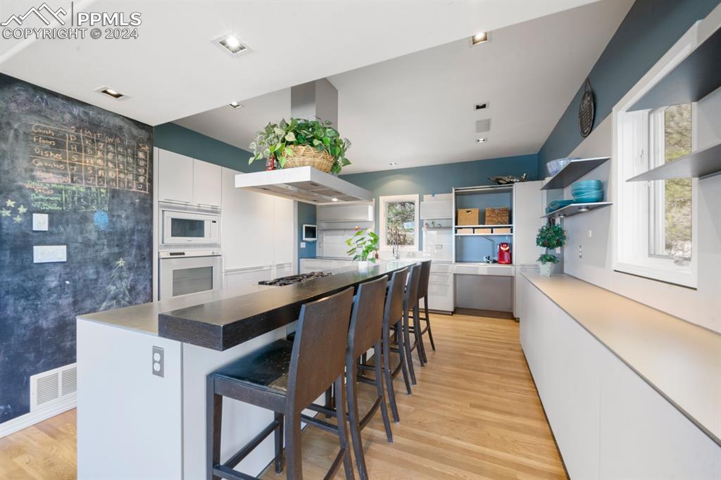 220 Preservation Way Colorado Springs, CO 80919 - Photo 3 of 39 a kitchen with stainless steel appliances a table and chairs in it